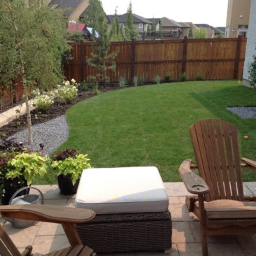 Backyard Seating Area and Lawn Landscape by European Garden Design Calgary