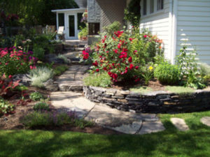 Flower Garden with Stonework by European Garden Design Calgary