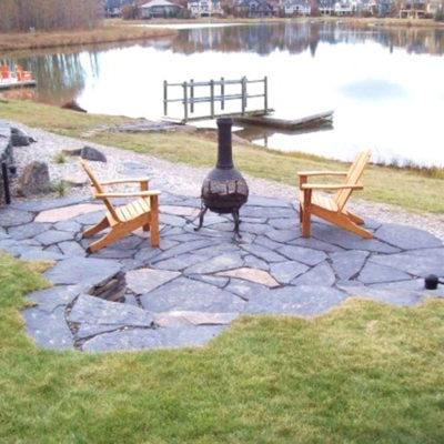 Stonework Patio Seating Area by European Garden Design Calgary
